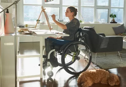 woman in wheelchair painting