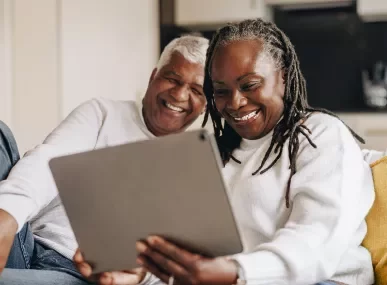 elder couple on tablet